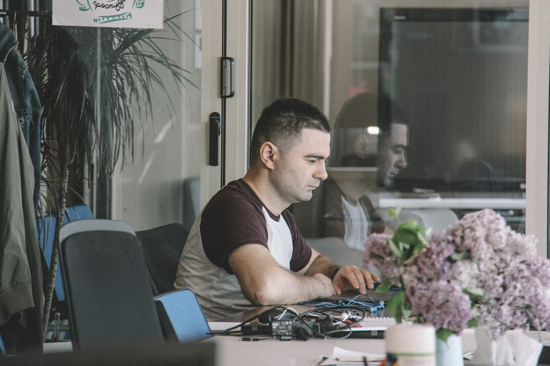successful programmer at desk